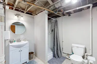 a bathroom with a toilet and a sink and a mirror at Work and Play! Home 1 Mi to Dtwn and Central Market in York