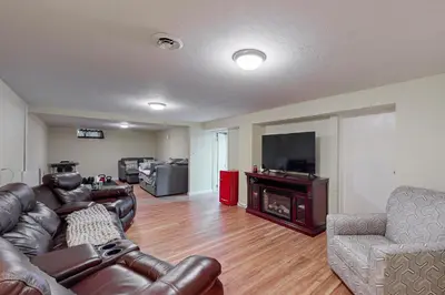 a living room with leather furniture and a fireplace at Work and Play! Home 1 Mi to Dtwn and Central Market in York