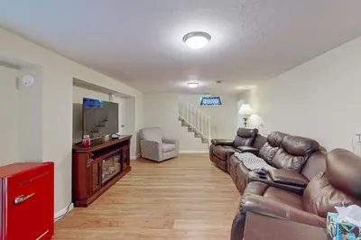 a living room with a couch and a flat screen tv at Work and Play! Home 1 Mi to Dtwn and Central Market in York