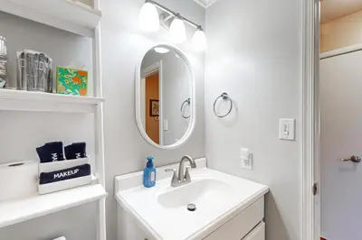 a white bathroom with a sink and a mirror at Work and Play! Home 1 Mi to Dtwn and Central Market in York