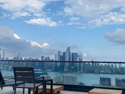 a balcony with a chair and a view of the city at Cozy apt with City skyline rooftop in Union City
