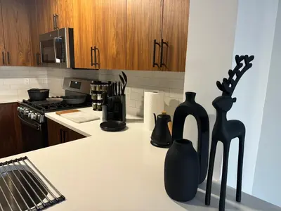 a kitchen with two black vases on a counter at Cozy apt with City skyline rooftop in Union City