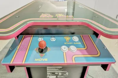 a shuffleboard game is shown in a room at Hip Dtwn Apt With Arcade And Gym in Binghamton