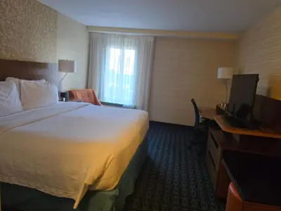 a hotel room with a bed and a television at Fairfield by Marriott in Paramus