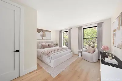 a white bedroom with a bed and a chair at Harlington by Rove Travel Private Backyard & Roof in New York
