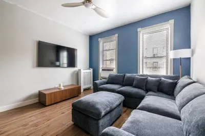 a living room with a couch and a tv at Ultimate Urban living at Centrally Located Apartments in New York