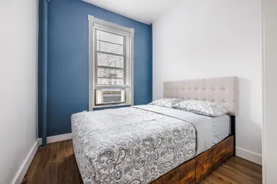 a bedroom with a bed and a window at Ultimate Urban living at Centrally Located Apartments in New York