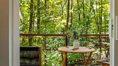 a table with a vase on top of a balcony at Hot Tub Lake Access Community Amenities Somerset Lodge by AvantStay in East Stroudsburg