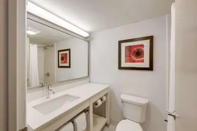 a white bathroom with a sink and a toilet at The Crossroads Hotel - Newburgh in Newburgh
