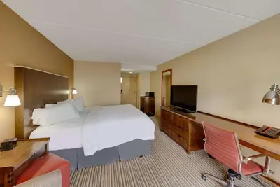 a hotel room with a large bed and a television at The Crossroads Hotel - Newburgh in Newburgh