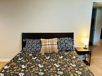 a bedroom with a bed with a floral comforter and pillows at Campu Whole House in Cherry Hill