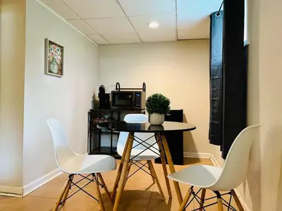a table and chairs in a room with a microwave at Campu Whole House in Cherry Hill