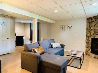 a living room with a blue couch and a fireplace at Campu Whole House in Cherry Hill