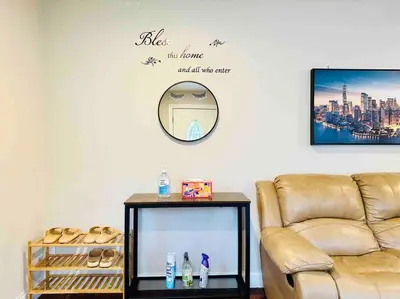 a living room with a couch and a mirror on the wall at Campu Whole House in Cherry Hill