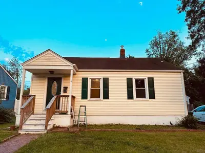 a white house with green shutters and a porch at Campu Whole House in Cherry Hill