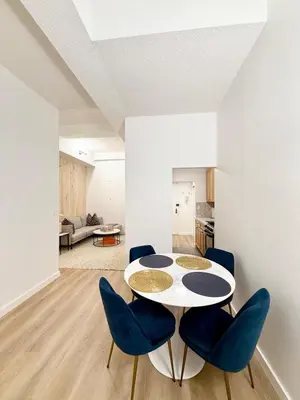 a dining room with a table and blue chairs at GREAT APT 2 BED ROOM GREAT LOCATION nye in New York