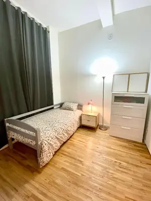 a bedroom with a bed and a dresser and a lamp at GREAT APT 2 BED ROOM GREAT LOCATION nye in New York