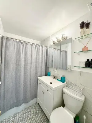 a white bathroom with a toilet and a sink at GREAT APT 2 BED ROOM GREAT LOCATION nye in New York