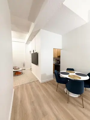 a white living room with a table and chairs at GREAT APT 2 BED ROOM GREAT LOCATION nye in New York