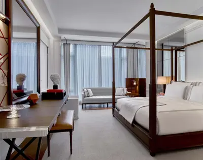 a bedroom with a bed and a desk and a room at Baccarat Hotel and Residences New York in New York