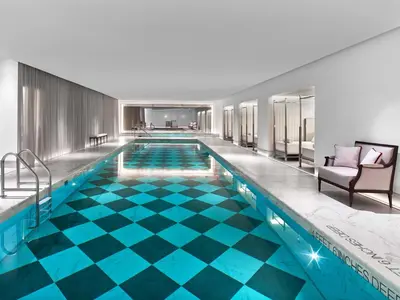 a pool in a hotel with a blue floor at Baccarat Hotel and Residences New York in New York