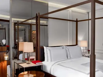 a bedroom with a large bed and two tables with lamps at Baccarat Hotel and Residences New York in New York