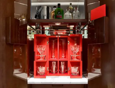 a red cabinet with wine glasses in it at Baccarat Hotel and Residences New York in New York