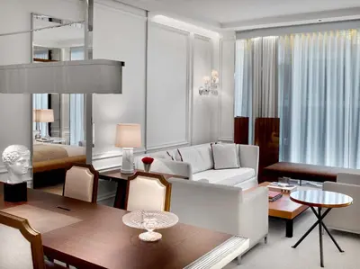 a living room with a white couch and a table at Baccarat Hotel and Residences New York in New York