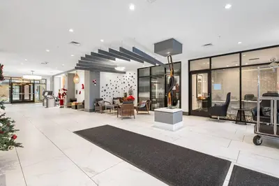 a lobby of a building with chairs and tables at Supreme 2 Bedroom Condo in Prime Jersey City in Jersey City