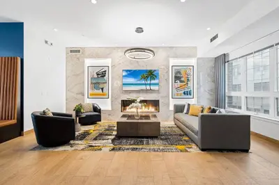 a living room with two couches and a fireplace at Supreme 2 Bedroom Condo in Prime Jersey City in Jersey City