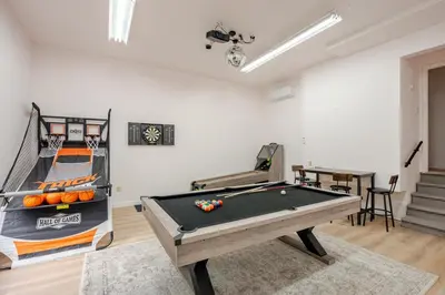 a room with a ping pong table and a basketball at Woodland Retreat in Blakeslee