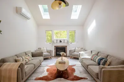 a living room with a couch and a table at Woodland Retreat in Blakeslee
