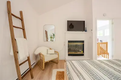 a bedroom with a bed and a fireplace at Woodland Retreat in Blakeslee