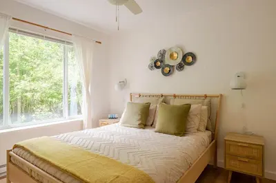 a bedroom with a large bed with a window at Woodland Retreat in Blakeslee