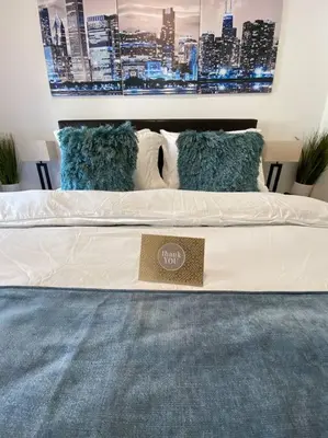 a bed with a sign on it in a room at Apart Studio West NY 12Mints From NYCIty Times Square in West New York