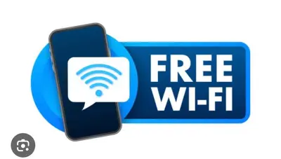 a free wifi sign and a cell phone with a wifi symbol at Apart Studio West NY 12Mints From NYCIty Times Square in West New York