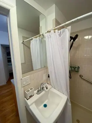a bathroom with a sink and a shower curtain at Apart Studio West NY 12Mints From NYCIty Times Square in West New York