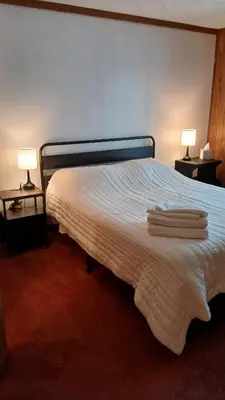 a bedroom with a bed with towels on it at Mountain Lake Retreat in Clifton