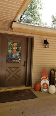 a porch with pumpkins and a door with a window at Mountain Lake Retreat in Clifton