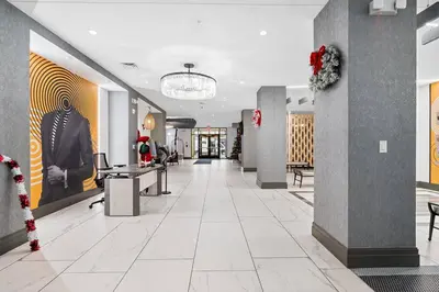 an empty lobby with a christmas decoration on the wall at Jersey City's Best Enjoy Our Deluxe 1 Bedroom Condo Only 25 Minutes to NYC in Jersey City