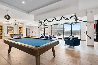 a living room with a pool table in it at Jersey City's Best Enjoy Our Deluxe 1 Bedroom Condo Only 25 Minutes to NYC in Jersey City