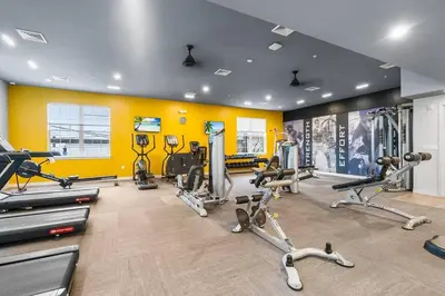 a gym with several tread machines in a room at Luxury Living in Jersey City Only Steps Away from Manhattan in Jersey City