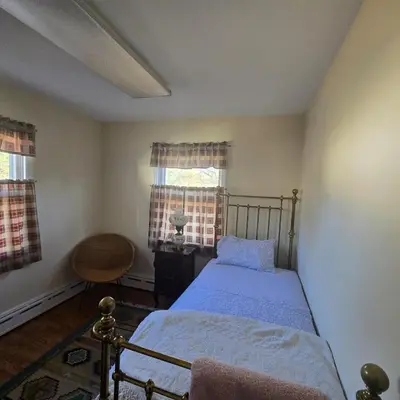 a bedroom with a bed and a window at The White House in Plainfield