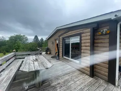 a cabin with a wooden deck with a table at Most relaxing place on earth in Livingston Manor