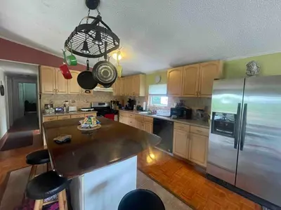 a kitchen with a stainless steel refrigerator and a chandelier at Most relaxing place on earth in Livingston Manor