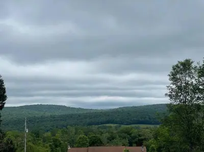 a view of a mountain with trees and a building at Most relaxing place on earth in Livingston Manor