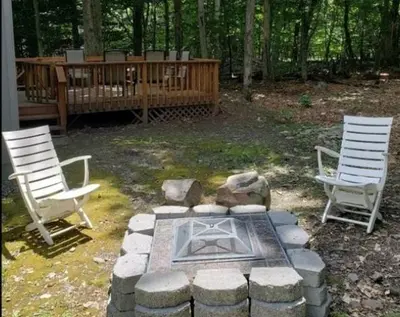 two chairs and a fire pit in a yard at Vdara Pocono Home in Tobyhanna