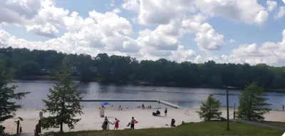 a group of people standing around a lake at Vdara Pocono Home in Tobyhanna