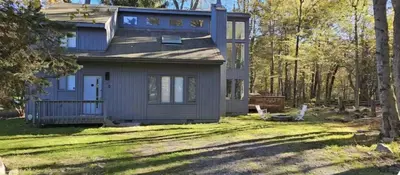a small house in the middle of a yard at Vdara Pocono Home in Tobyhanna