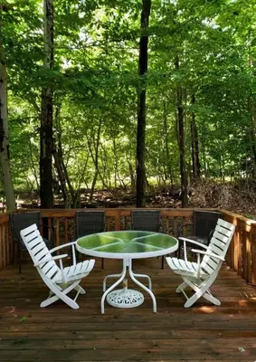 a table and two chairs on a wooden deck at Vdara Pocono Home in Tobyhanna